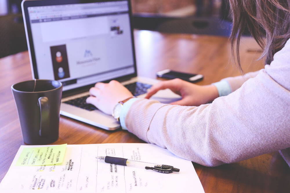 Photo of a person working on a laptop, symbolising remote learning.